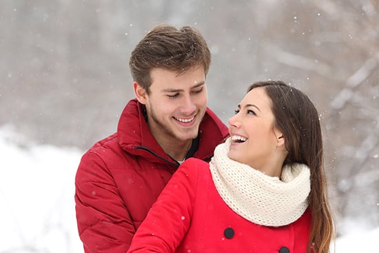Couple falling in love at first sight in winter outdoors while snowing